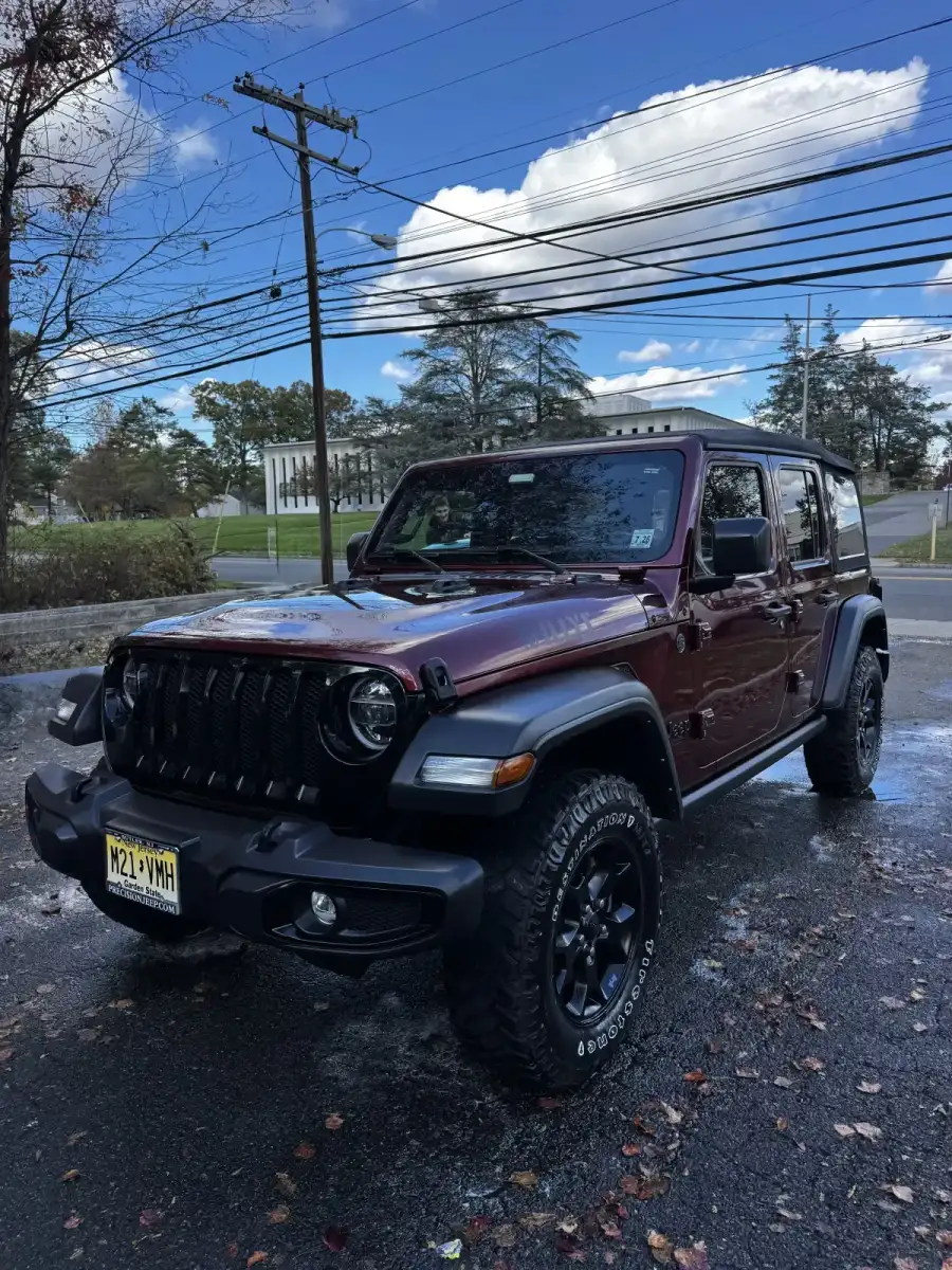 Exterior car detailing in Morris County NJ, red Jeep cleaned to a showroom shine